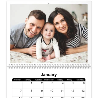 Wall Calendars: A personalized wall calendar open to January 2024, with a large family photo on the top page.r