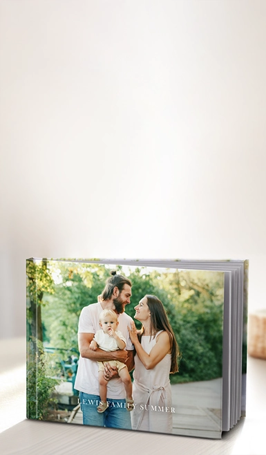 Bestselling Photo Books: A landscape hardcover photo book with a full-photo cover of a family and a personalized title.