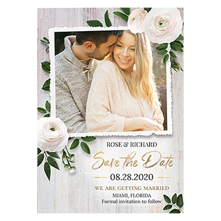 Wedding cards & invitations: A rustic Save the Date card featuring a photo of a smiling couple with a torn edge, surrounded by white ranunculus flowers and green leaves on a white wooden background, with text reading ROSE & RICHARD, Save the Date, 08.28.2020, WE ARE GETTING MARRIED, MIAMI, FLORIDA, Formal invitation to follow.
