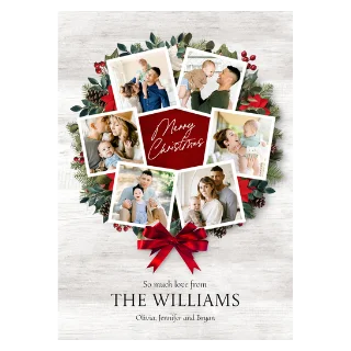 Rustic Wreath Card 5x7: A multi-photo Christmas card featuring a wreath of pine, berries, and poinsettias on a white distressed wood background, with eight square photos of a family with a baby, and a central red octagon with the text Merry Christmas.