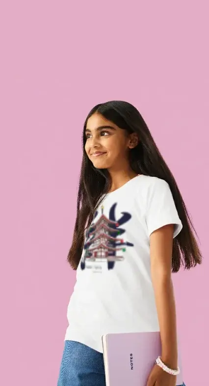 Customizable apparel: A girl in a white t-shirt and blue jeans, looking up and to the side, holding a small lavender notebook against a solid pink background.