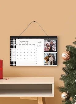 Custom Wall Calendars: A personalized wall keepsake calendar with a black and white plaid border, showing two square photos of a couple next to the month of January 2026.
